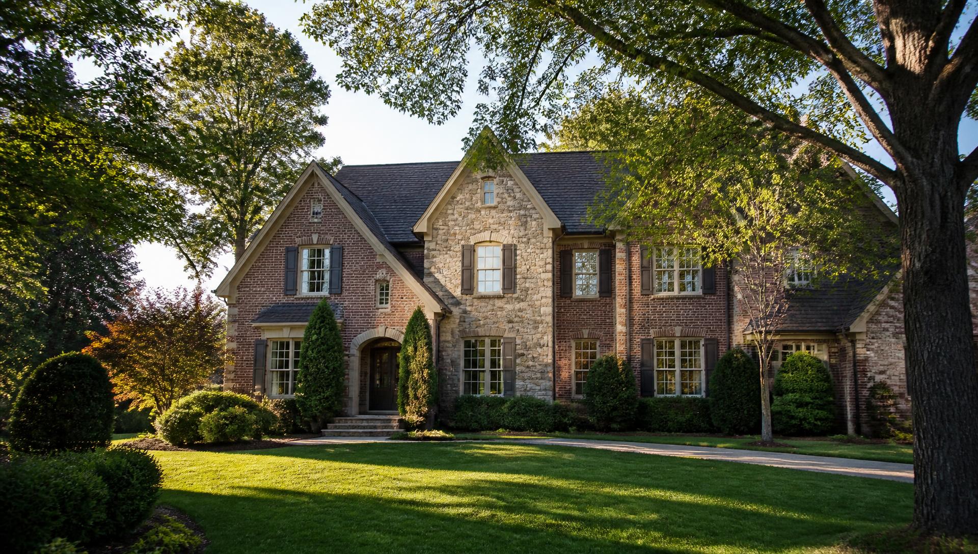 Brick and stone custom home with mature oak trees in Montibello, south Charlotte